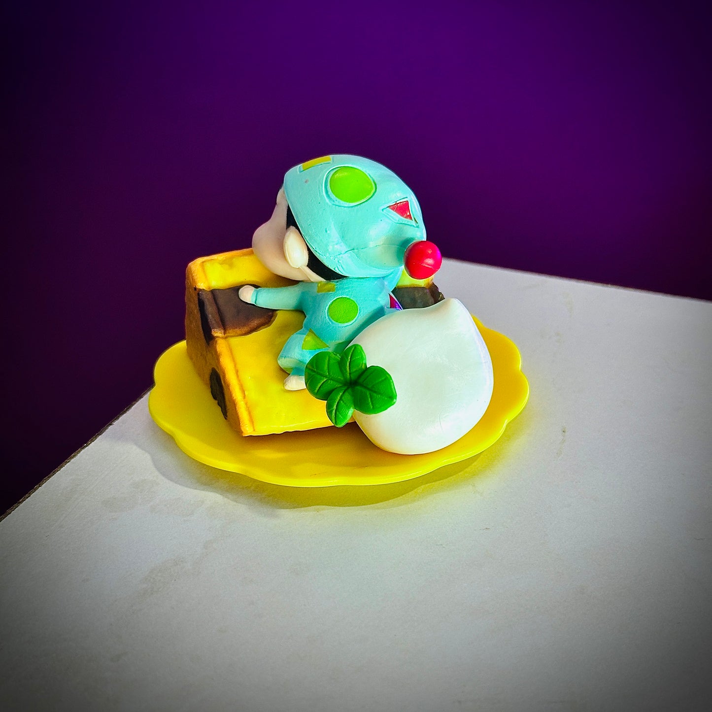 Cute Shinchan anime resin figure lying on cheese block
