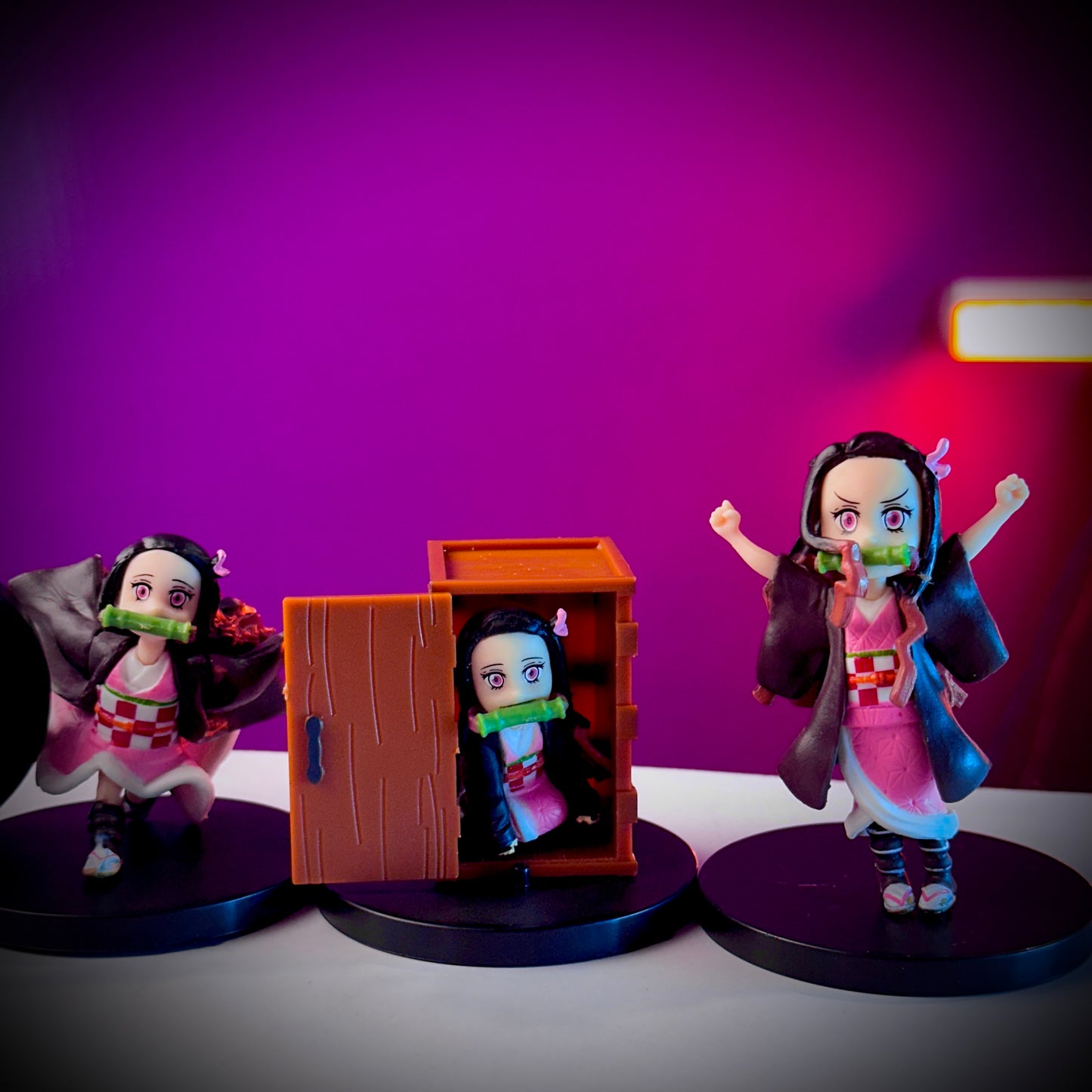 Three figurines of a character with a purple background