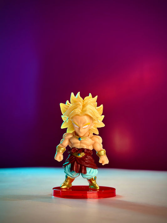 Super Saiyan character figurine on a red stand against a purple background
