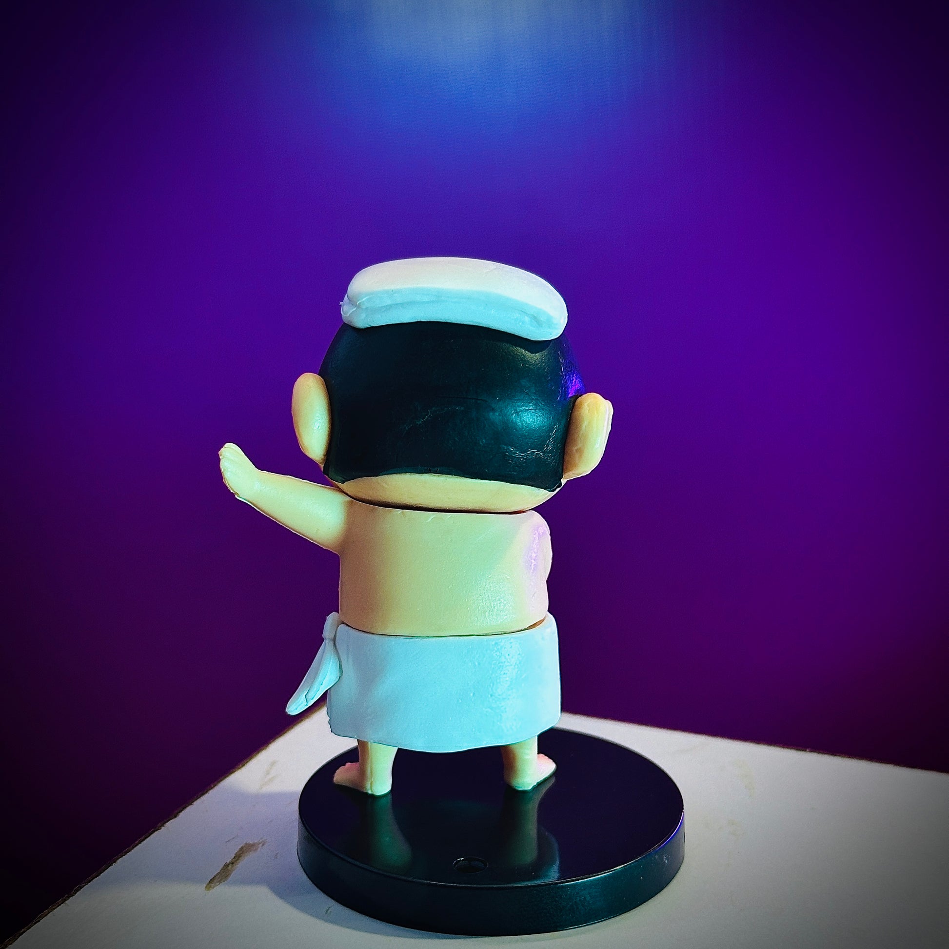 Shinchan towel pose collectible figure on table