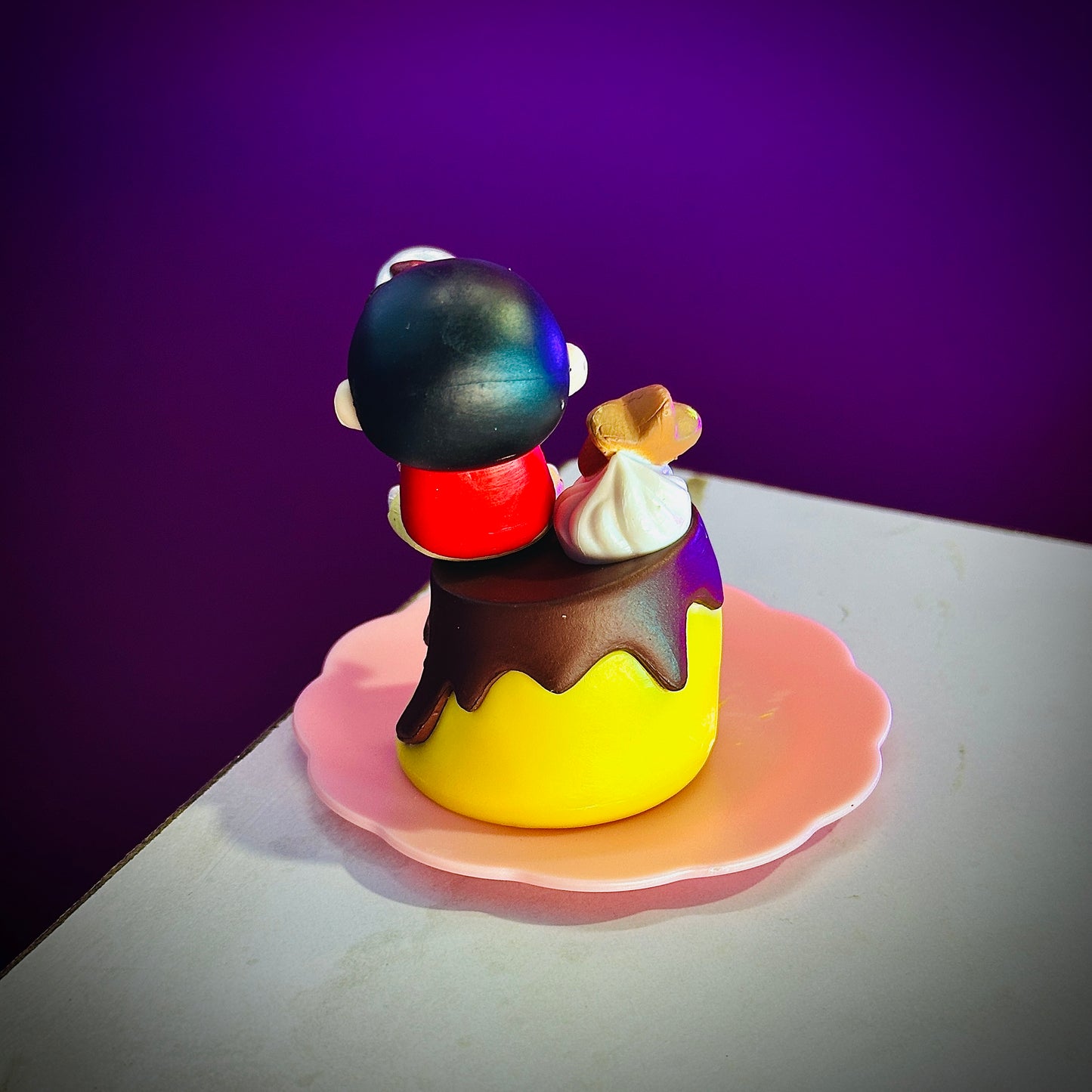 Cute Shinchan anime collectible eating dessert on yellow cup