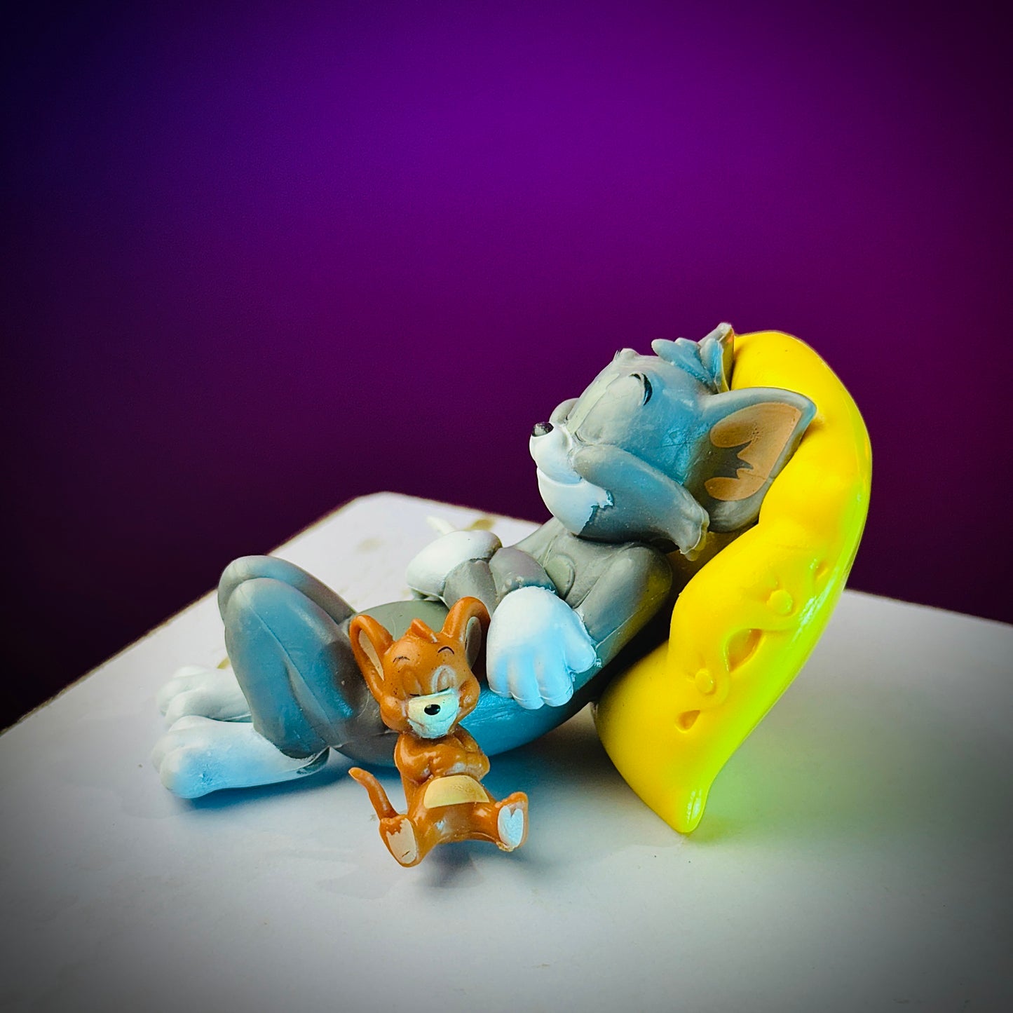 tom and jerry toy sitting on pillow