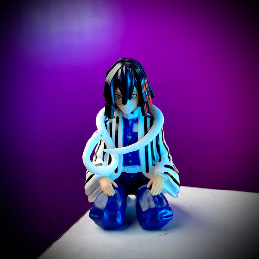 Figurine with blue hair and striped outfit against a purple background