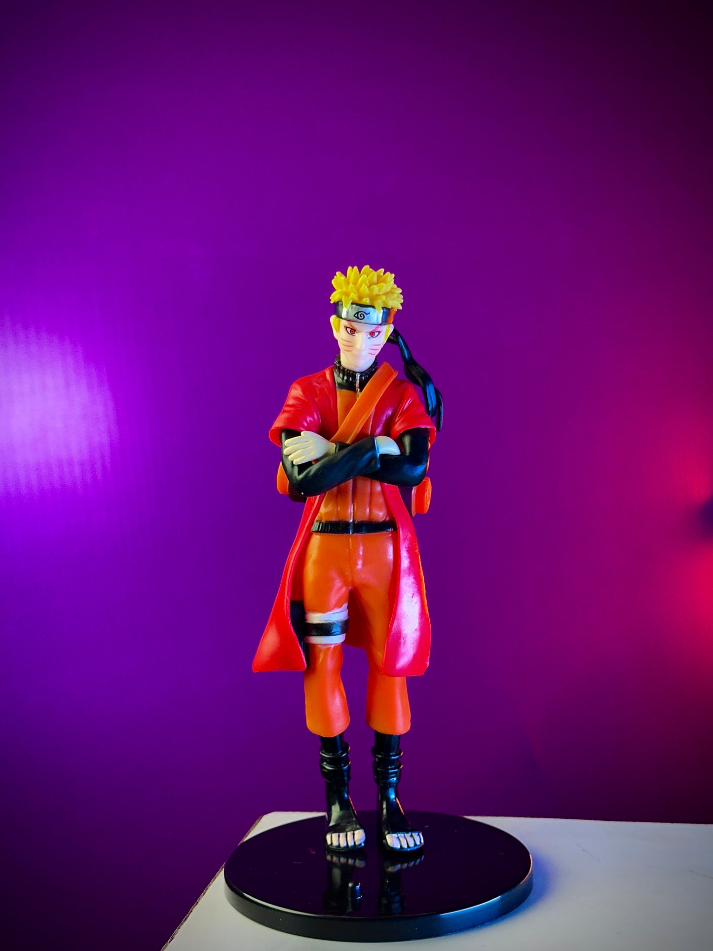 Action figure in orange outfit with yellow hair on a purple background
