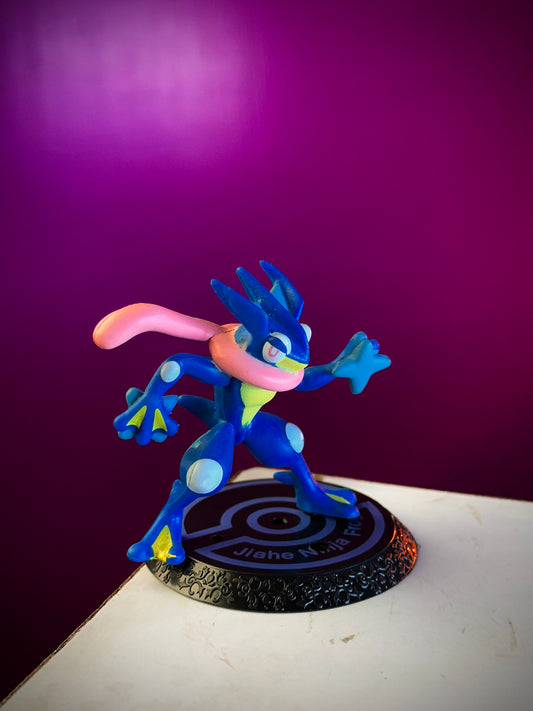 Blue and pink cartoon character figurine on a purple background