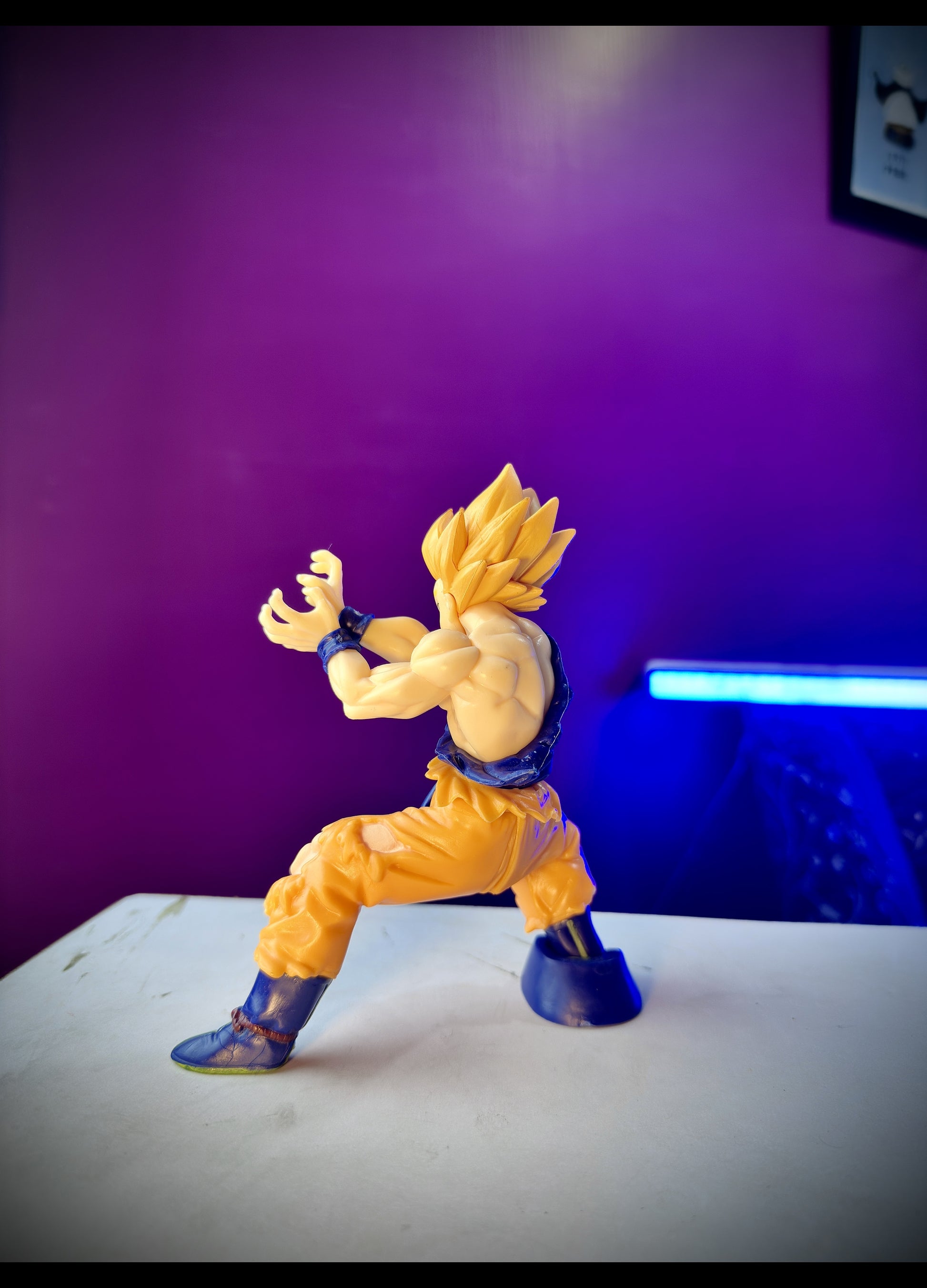 Anime figure of Goku in Super Saiyan form performing Kamehameha attack pose