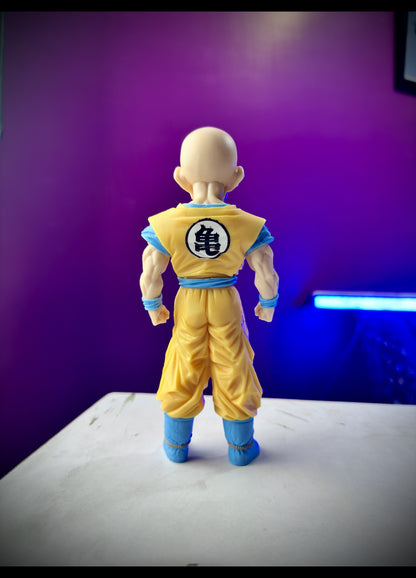 Anime figure of Krillin in orange outfit standing ready for battle from Dragon Ball Z
