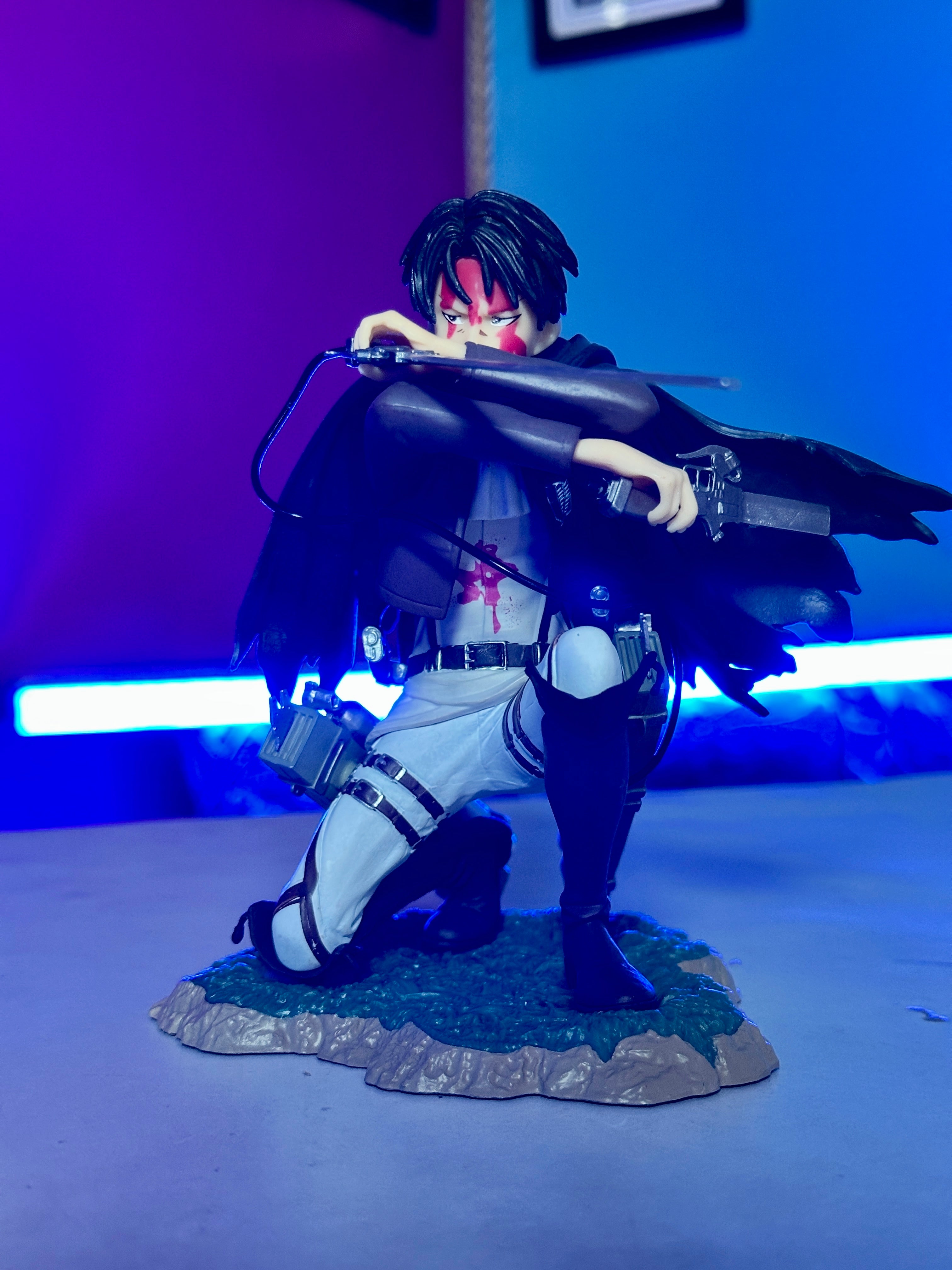 Detailed Levi Ackerman anime statue with swords and cape
