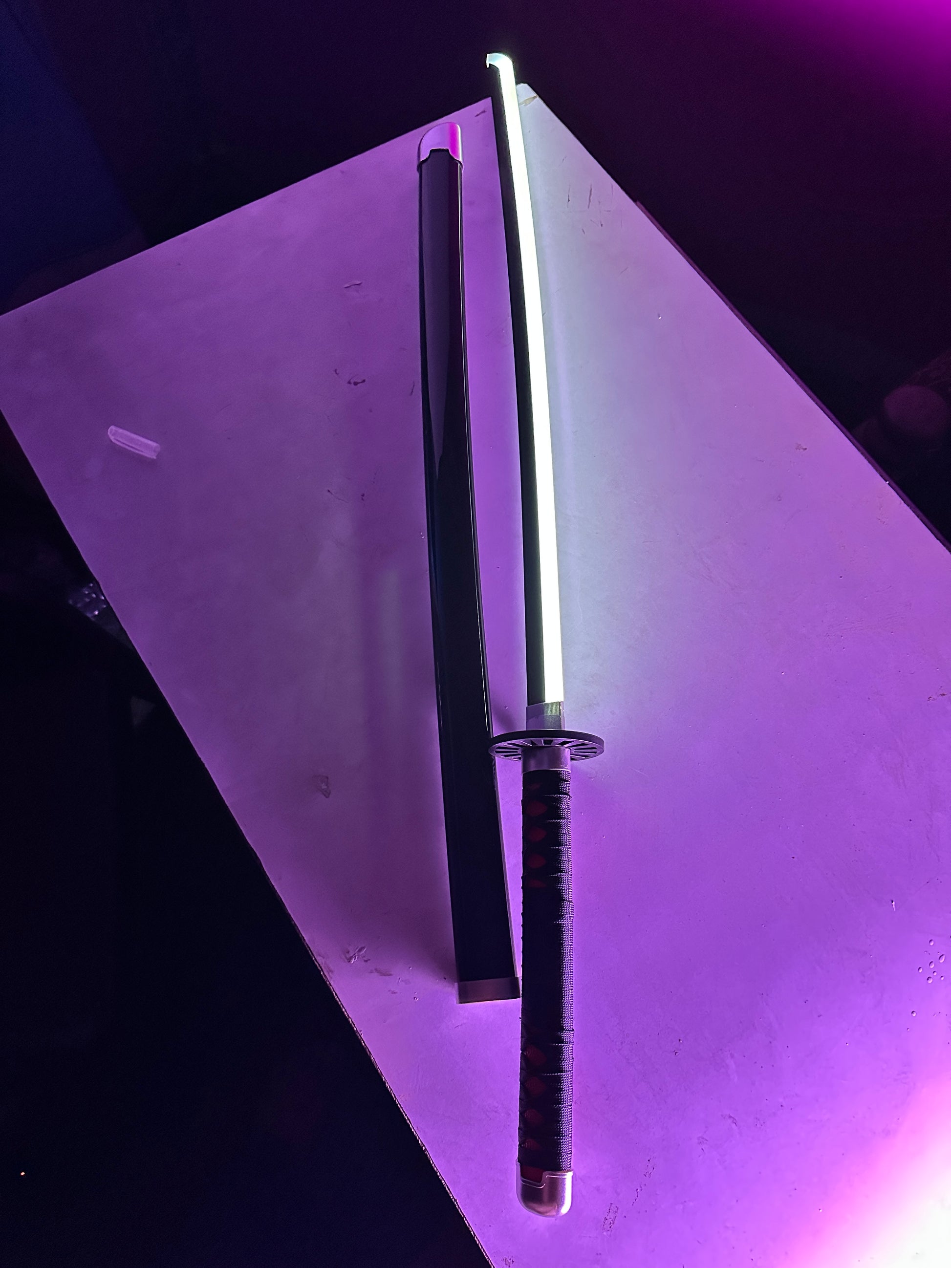 Demon Slayer Tanjiro cosplay sword with LED lighting, detailed grip wrap, and display-ready construction
