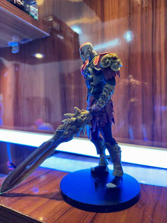 Detailed Kratos collectible figure from God of War featuring warrior armor and sword.