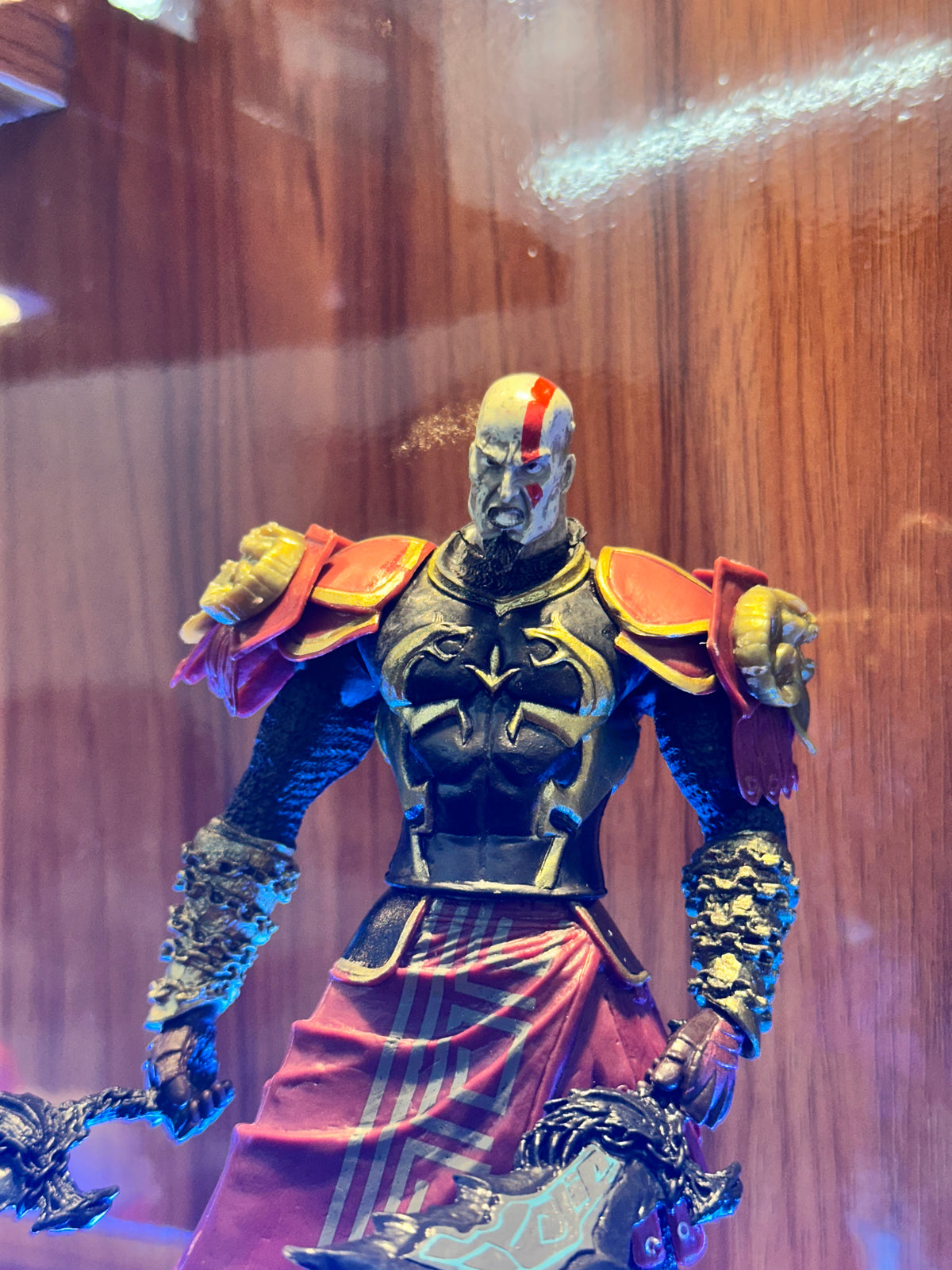 Detailed Kratos collectible figure from God of War featuring his iconic blade and warrior design.
