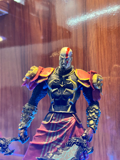 Detailed Kratos collectible figure from God of War featuring his iconic blade and warrior design.

