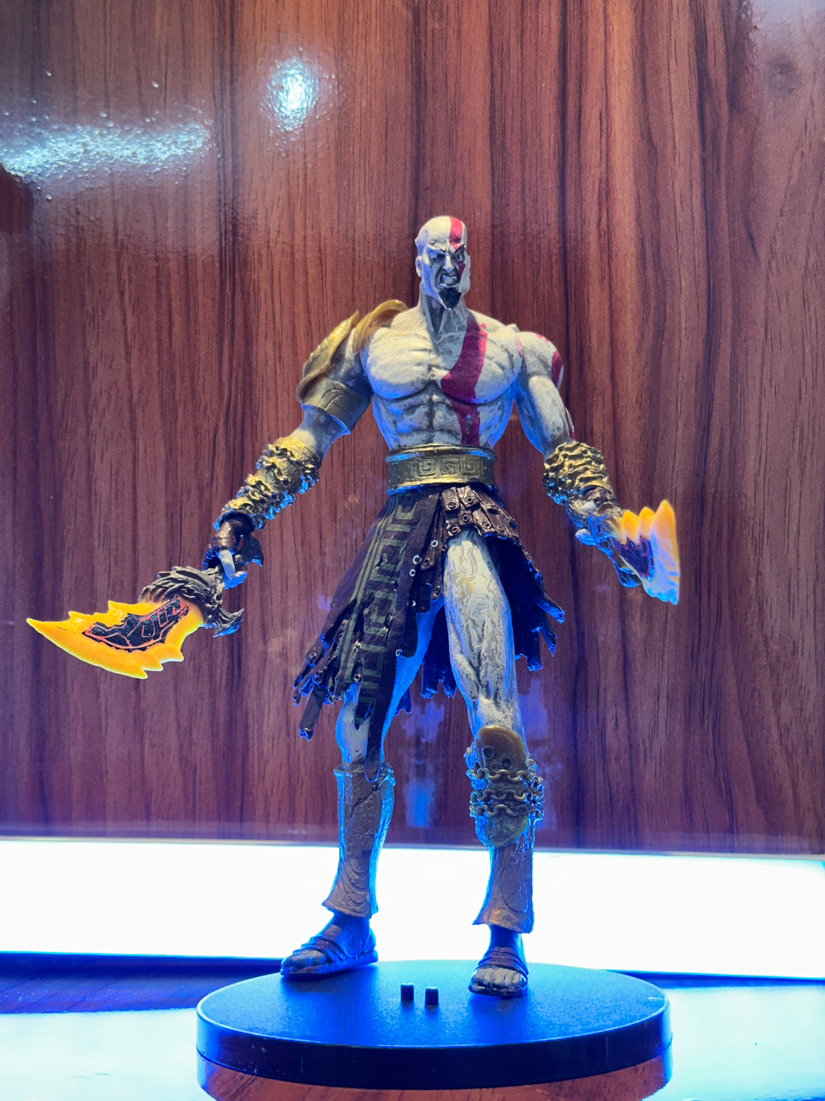Detailed Kratos collectible figure from God of War featuring his iconic blade and warrior design.