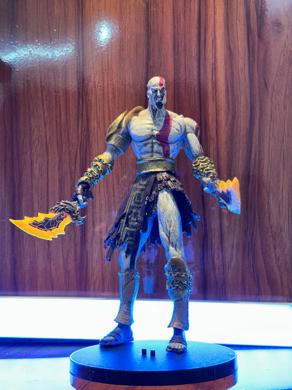 Detailed Kratos collectible figure from God of War featuring his iconic blade and warrior design.