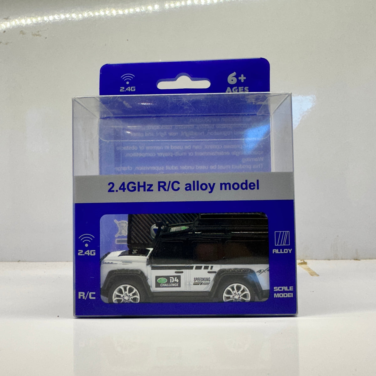 2.4GHz rechargeable remote control car for kids featuring a black and white mini SUV design.