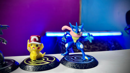 Four Pokemon mini figures including Pikachu Greninja Charizard and Venusaur on display bases