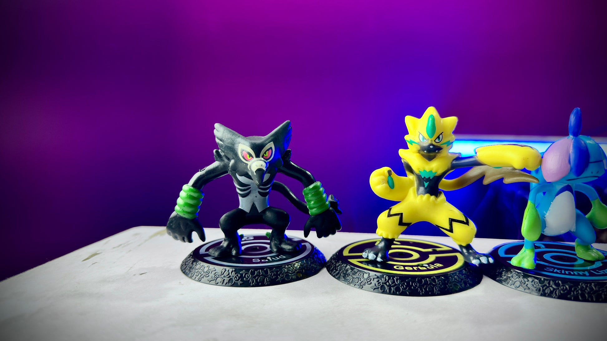 Four Pokemon mini figures standing on black display bases in a collectible set